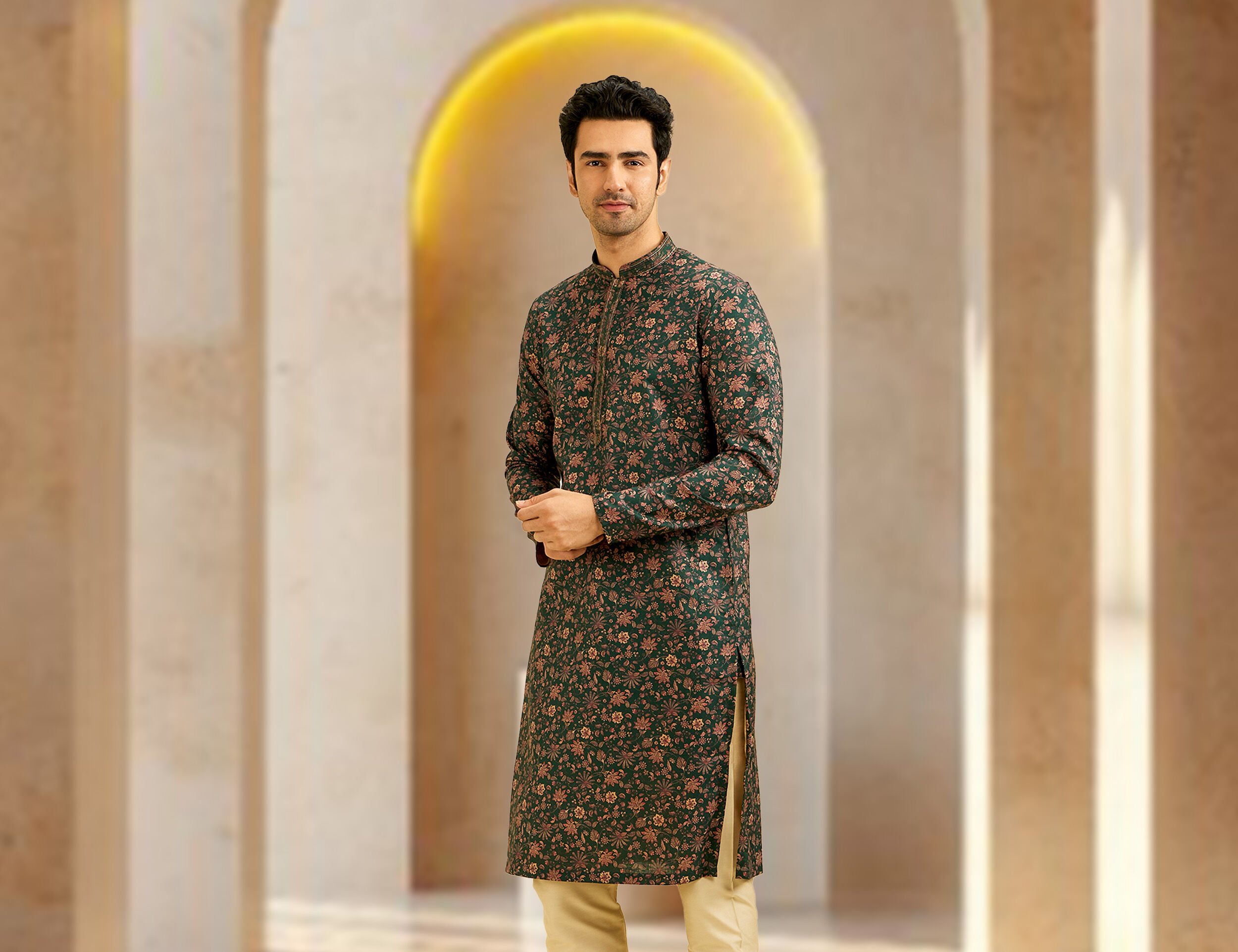 A men in green formal kurta with flowers pattern on it